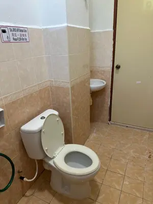 a bathroom with a toilet and a sink at GS HOMESTAY WHOLE VILLA in Bayan Lepas