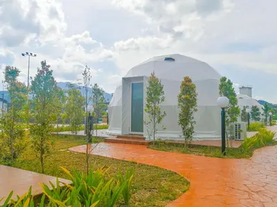 a large dome building with trees in front of it at The Dome @ Gua Musang in Gua Musang