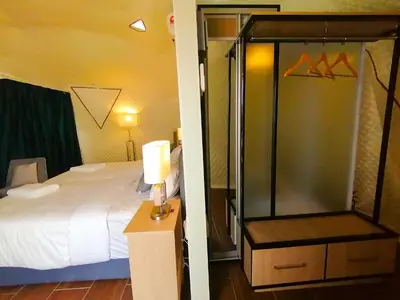 a bedroom with a bed and a glass shower at The Dome @ Gua Musang in Gua Musang