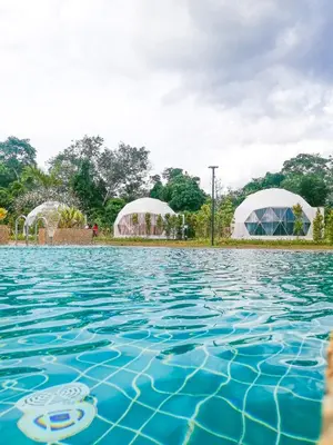 a swimming pool with two white domes and the water at The Dome @ Gua Musang in Gua Musang