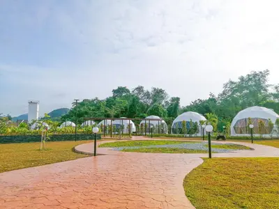 a park with domes and tents in the grass at The Dome @ Gua Musang in Gua Musang