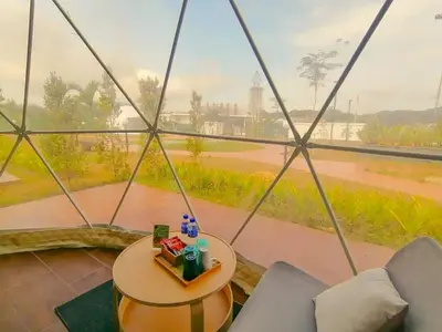 a room with a round table and a view of a river at The Dome @ Gua Musang in Gua Musang