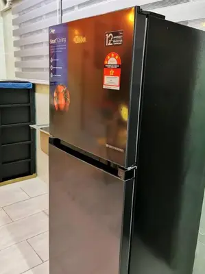 a black refrigerator sitting in a kitchen at English comfort house in ipoh by SuccessWisdom\u5ea6\u5047\u667a\u5bcc in Ipoh