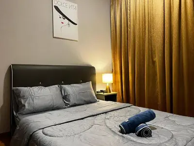 a bedroom with a bed with a blue object on it at Ipoh Cozy Modern Suite 6-7pax @ Adson's Home in Ipoh