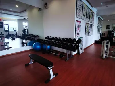 a gym with dumbbells and weights in a room at Ipoh Cozy Modern Suite 6-7pax @ Adson's Home in Ipoh