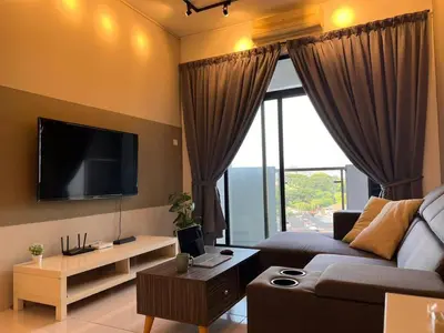 a living room with a couch and a tv at Ipoh Cozy Modern Suite 6-7pax @ Adson's Home in Ipoh