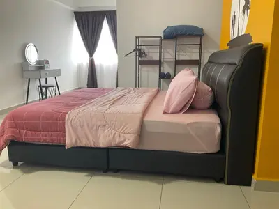 a bedroom with a large bed with pink pillows at Sweet Homestay The Venus Sitiawan \u6e29\u99a8\u6c11\u5bbf in Sitiawan