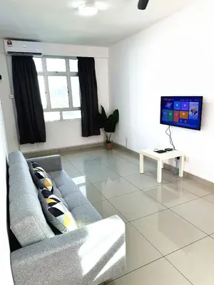 a living room with a couch and a tv at TuR10-Oppesite Pisa Stadium-1min-FoodCourt-MiniMarket in Bayan Lepas