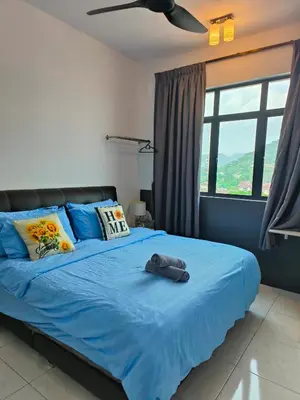 a bedroom with a blue bed with a blue blanket at New The Sun Homestay at Sg Nibong nearby Queensbay or PISA or FTZ Bayan Lepas HENG in Bayan Lepas