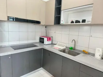 a kitchen with a sink and a microwave at New The Sun Homestay at Sg Nibong nearby Queensbay or PISA or FTZ Bayan Lepas HENG in Bayan Lepas