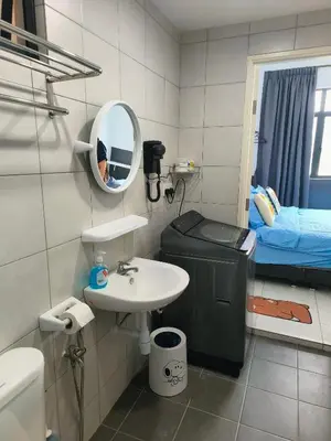a bathroom with a sink and a mirror and a bed at New The Sun Homestay at Sg Nibong nearby Queensbay or PISA or FTZ Bayan Lepas HENG in Bayan Lepas