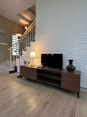a living room with a flat screen tv on a cabinet at Ipoh Luxury Spacious Corner Home in Ipoh