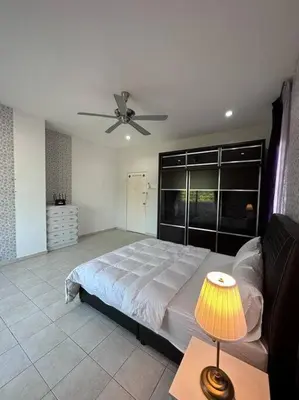 a bedroom with a bed and a ceiling fan at Ipoh Luxury Spacious Corner Home in Ipoh