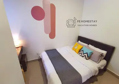 a small bedroom with a bed with colorful pillows at FE Cozy Cameron Homestay Family 8 pax 3BR Palas Horizon Brinchang \u91d1\u9a6c\u4f26\u6c11\u5bbf 8\u4eba3\u623f in Brinchang