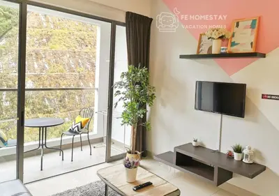 a living room with a tv and a large window at FE Cozy Cameron Homestay Family 8 pax 3BR Palas Horizon Brinchang \u91d1\u9a6c\u4f26\u6c11\u5bbf 8\u4eba3\u623f in Brinchang