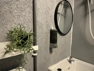 a bathroom with a mirror and a sink at GRAYHAUS INN Ipoh in Ipoh