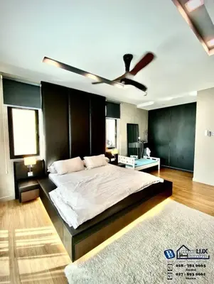 a bedroom with a large bed with a ceiling fan at Batu Ferringhi Luxurious Modern Designed 5BR House in Batu Ferringhi