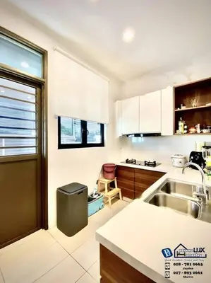 a kitchen with white cabinets and a sink at Batu Ferringhi Luxurious Modern Designed 5BR House in Batu Ferringhi