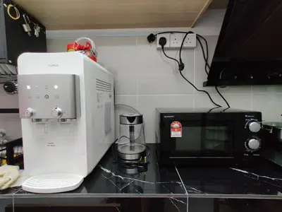 a kitchen counter with a coffee maker and a microwave at Hygge Living Kampar (Near UTAR) in Kampar