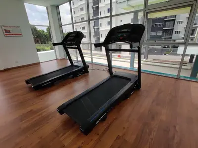 two exercise machines in a room with a large window at Hygge Living Kampar (Near UTAR) in Kampar