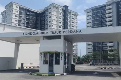 a gas station in front of some tall buildings at Hygge Living Kampar (Near UTAR) in Kampar
