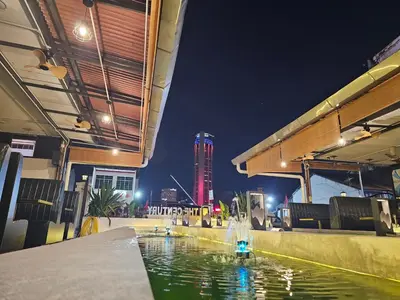 a pool of water with a building in the background at The Century Hotel George Town \u4e54\u6cbb\u5e02\u4e16\u7eaa\u9152\u5e97 in George Town