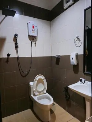 a bathroom with a toilet and a sink at The Century Hotel George Town \u4e54\u6cbb\u5e02\u4e16\u7eaa\u9152\u5e97 in George Town