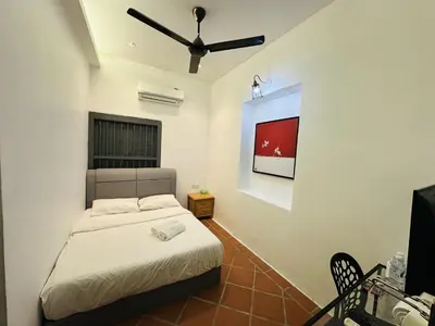 a bedroom with a bed and a flat screen tv at The Century Aigoh Hotel in George Town