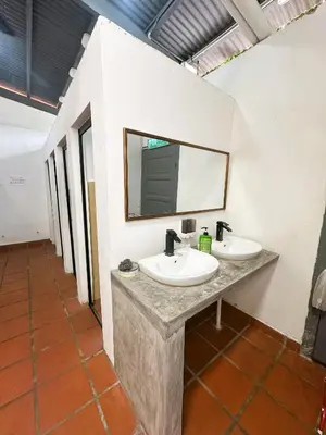 a bathroom with two sinks and a mirror at The Century Aigoh Hotel in George Town