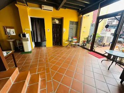 a room with a tile floor and yellow walls at The Century Aigoh Hotel in George Town