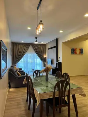 a dining room table and chairs in a living room at Lucky Home @ Quintet Tanah Rata in Cameron Highlands