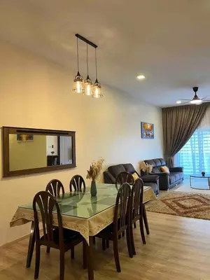 a dining room with a table and chairs and a couch at Lucky Home @ Quintet Tanah Rata in Cameron Highlands