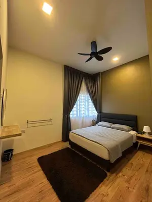 a bedroom with a bed and a ceiling fan at Lucky Home @ Quintet Tanah Rata in Cameron Highlands