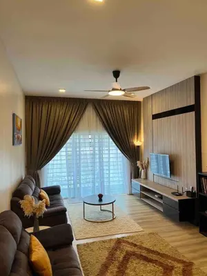 a living room with a couch and a table and a television at Lucky Home @ Quintet Tanah Rata in Cameron Highlands