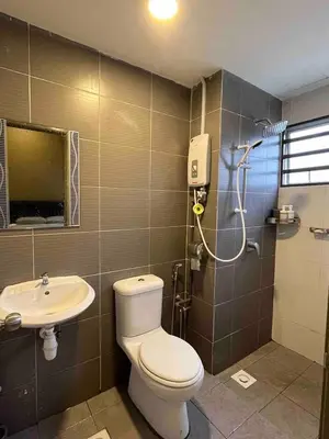a bathroom with a toilet and a sink at Lucky Home @ Quintet Tanah Rata in Cameron Highlands