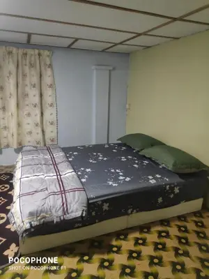 a large bed in a room with at Kurnia Homestay in Slim River
