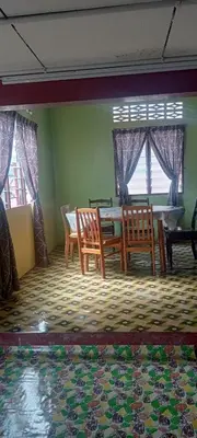 a dining room with a table and two chairs at Kurnia Homestay in Slim River