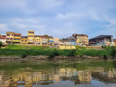 a group of buildings sitting next to a river at Lipis Riverfront Resort in Kuala Lipis