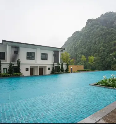 a large swimming pool in front of a building at Onsen Oasis Premium Suites in Tambun