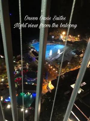 a view from the window of an amusement park at night at Onsen Oasis Premium Suites in Tambun