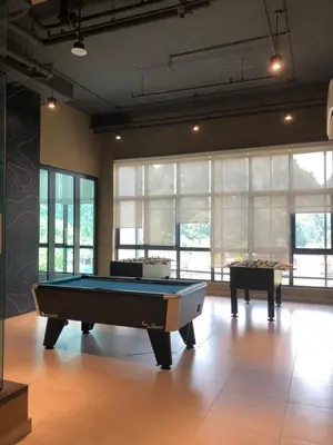 a room with a pool table and two tables at Onsen Oasis Premium Suites in Tambun