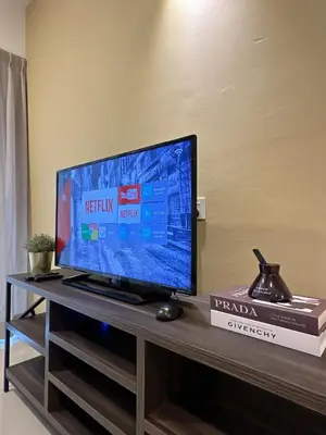 a flat screen tv sitting on top of a table at Ipoh Town - Majestic Cozy Deluxe Homestay in Ipoh