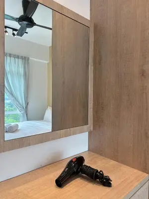 a hair dryer sitting on a counter in front of a mirror at Ipoh Town - Majestic Cozy Deluxe Homestay in Ipoh