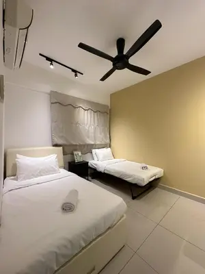 a bedroom with two beds and a ceiling fan at Ipoh Town - Majestic Cozy Deluxe Homestay in Ipoh