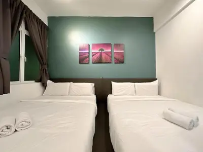 two beds in a room with white sheets at Ipoh Town - Majestic Cozy Deluxe Homestay in Ipoh