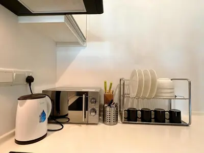 a kitchen counter with a coffeemaker and a coffee maker at Ipoh Town - Majestic Cozy Deluxe Homestay in Ipoh