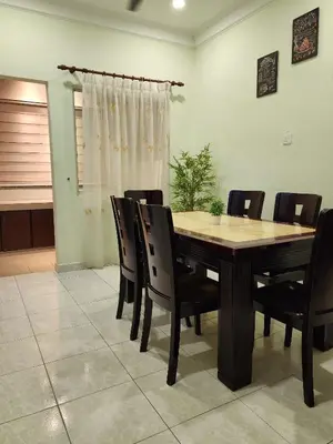 a dining room with a wooden table and chairs at Galaxy Guest Home by Ipoh Maju Stay in Ipoh
