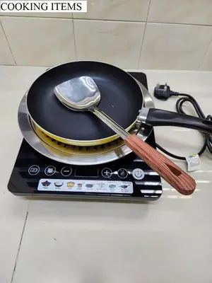 a frying pan with two spoons on top of it at Galaxy Guest Home by Ipoh Maju Stay in Ipoh