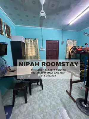 a room with a wooden table with a sign on it at NIPAH ROOMSTAY PARIT BUNTAR in Parit Buntar