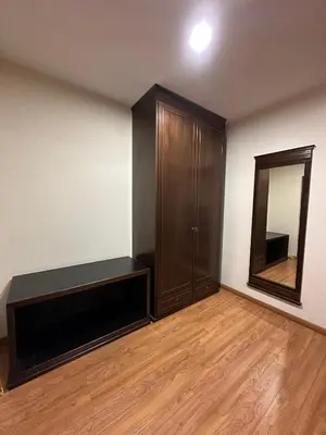 an empty room with a cabinet and a mirror at Maxwell inn in Taiping